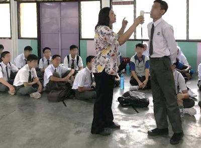 Smoking Cessation Specialist Sister Swinder does a Smokelyzer test on a student